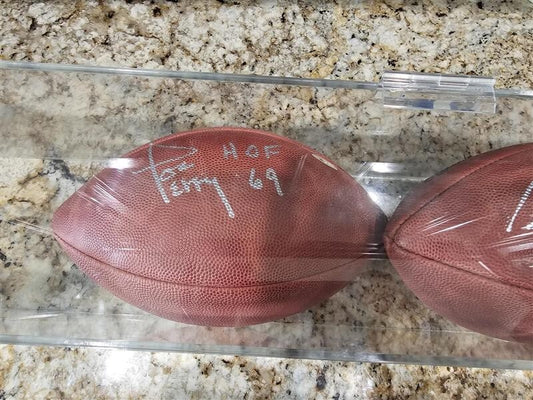 Bart Starr, Joe Perry, and Roger Staubach signed footballs in Display case