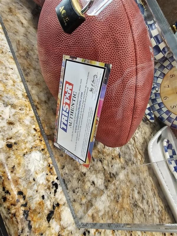 Bart Starr, Joe Perry, and Roger Staubach signed footballs in Display case