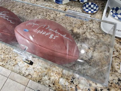 Bart Starr, Joe Perry, and Roger Staubach signed footballs in Display case