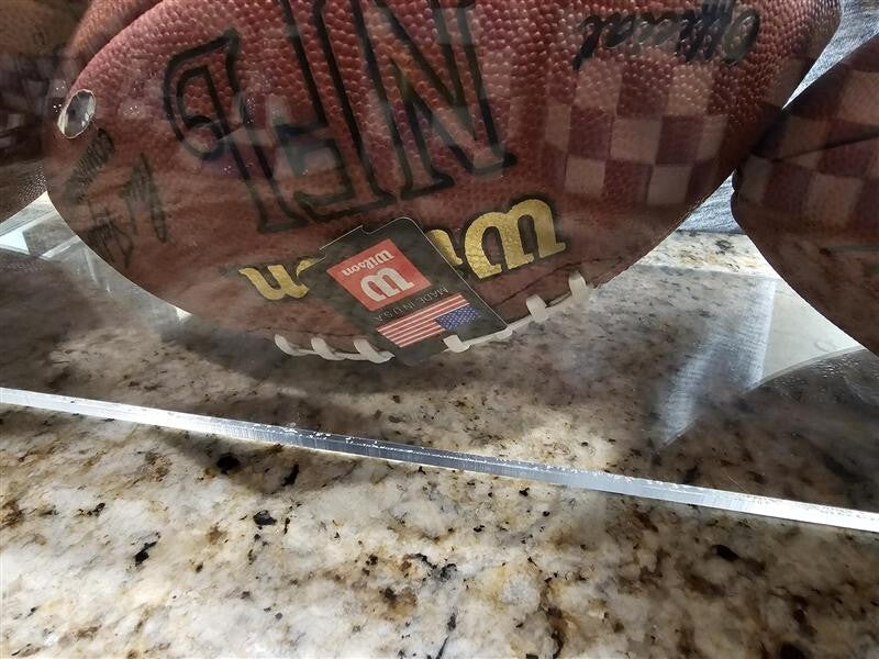 Bart Starr, Joe Perry, and Roger Staubach signed footballs in Display case